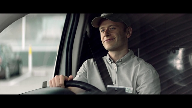 Video Reference: Photograph, Snapshot, Photography, Automotive design, Headgear, Gentleman, Smile, White-collar worker, Sitting, Driving, Person, Man, Indoor, Window, Looking, Laptop, Front, Computer, Table, Photo, Screen, Using, Holding, Wearing, Woman, Standing, Shirt, Glasses, Young, Kitchen, Human face, Clothing, Screenshot, Hat, Fashion accessory, Car, Portrait