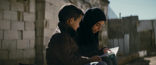 Video Reference: Interaction, Fun, Adaptation, Sitting, Photography, Reading, Electronic device, Conversation, Student, Smile, Person, Building, Man, Woman, Looking, Young, Using, Holding, Table, Boy, Laptop, Street, Black, Standing, Riding, Phone, Computer, Living, People, Playing, Luggage, Room, City, White, Human face, Clothing