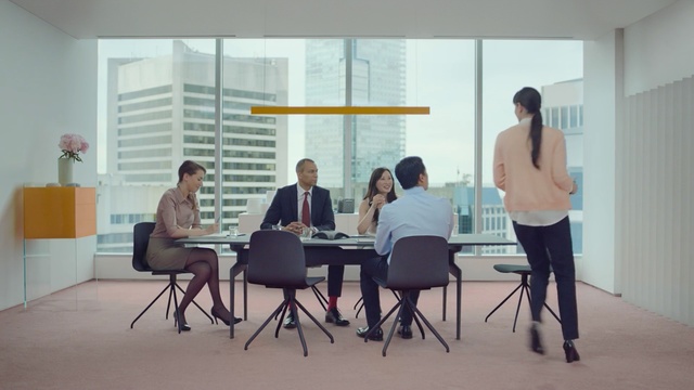 Video Reference: Room, Furniture, Design, Interior design, Table, Office, Sitting, Event, Architecture, Job, Person