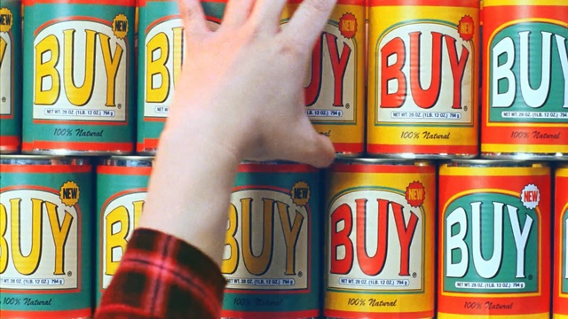 Video Reference: Beverage can, Drink, Tin can, Aluminum can, Soft drink, Beer, Can, Thing, Container, Building, Food, Computer, Man, Table, Holding, Standing, Phone, Street, Text, Bottle, Snack