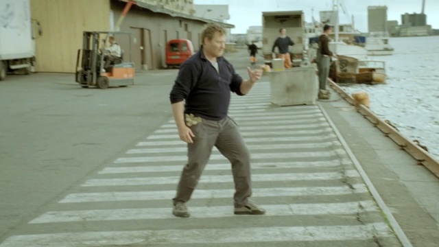 Video Reference: standing, road, boardwalk, floor, walkway, pedestrian, flooring, sidewalk, Person