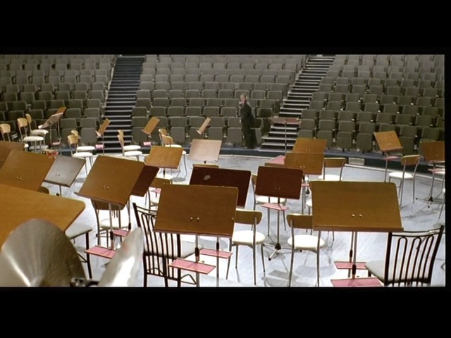 Video Reference: Auditorium, Chair, Table, Furniture, Design, Restaurant, Room, Function hall, Architecture, Building, Person