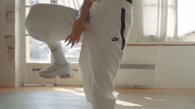 Video Reference: White, Clothing, Standing, Leg, Shoulder, Joint, Footwear, Outerwear, Human body, Hip