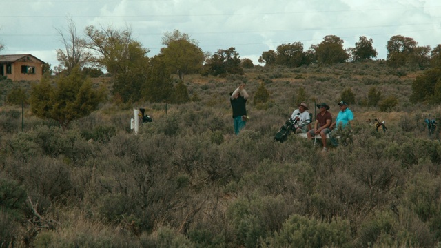 Video Reference: Shrubland, Vegetation, Grassland, Plant community, Natural environment, Wilderness, Prairie, Grass, Grass family, Soil, Outdoor, Field, Grassy, Standing, Group, Man, Open, People, Playing, Green, Walking, Large, Hill, Riding, Horse, Flying, Tall, Grazing, Young, Kite, Sky, Tree, Person, Hiking, Plant, Day, Distance