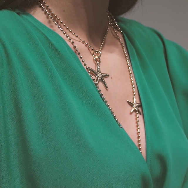 Video Reference: Aqua, Turquoise, Teal, Neck, Jewellery, Fashion accessory, Necklace, Body jewelry, Electric blue, Person, Green, Woman, Wearing, Clothing, Cellphone, Shirt, Lady, Holding, Phone, Jacket, Smiling, Hat, Standing, Dress, Young, Man, Glasses, Blue, Street, Red, Human face, Fashion, Earrings