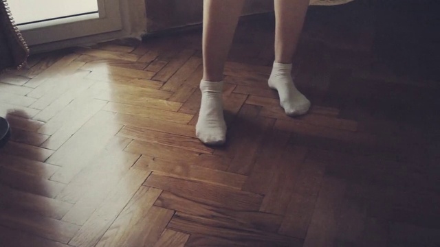 Video Reference: Floor, Hardwood, Wood flooring, Flooring, Wood, Leg, Laminate flooring, Footwear, Human leg, Shoe, Building, Indoor, Person, Window, Woman, Room, Standing, Kitchen, Front, Sitting, White, Small, Holding, Table, Young, Cat, Living, Black, Girl, Wooden, Refrigerator, Large, Man, Playing, Oven, Sandal, Feet, High heels, Ankle, Boot, Trousers