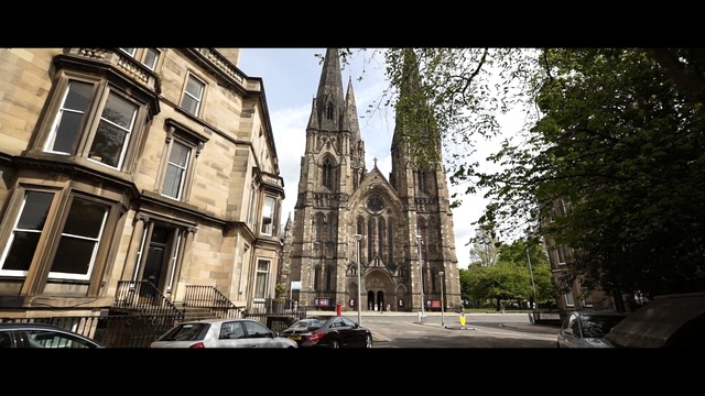 Video Reference: building, sky, landmark, urban area, town, tree, street, architecture, metropolis, city