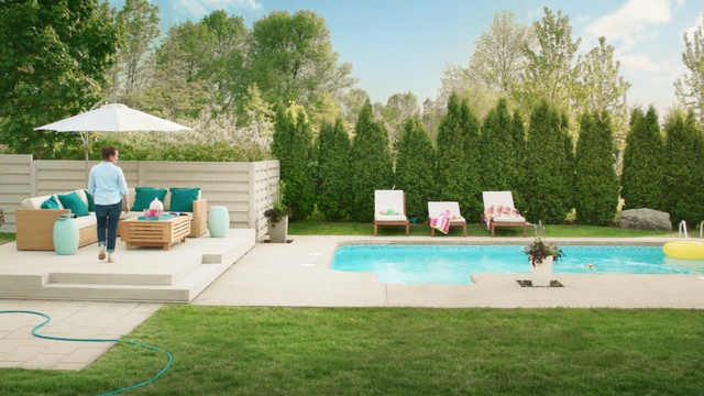 Video Reference: swimming pool, leisure, property, backyard, yard, estate, grass, house, lawn, recreation, Person