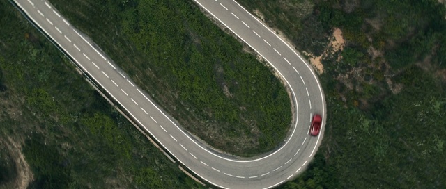 Video Reference: Road, Race track, Mountain pass, Lane, Thoroughfare, Infrastructure, Junction, Asphalt, Aerial photography, Sport venue