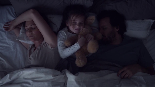 Video Reference: People, Child, Sleep, Fun, Nap, Bedtime, Birth, Gesture, Comfort, Baby, Person, Indoor, Bed, Sitting, Girl, Little, Laying, Holding, Small, Woman, Young, Lying, Stuffed, Bear, Laptop, Man, Table, Sleeping, White, Playing, Toddler, Human face, Clothing
