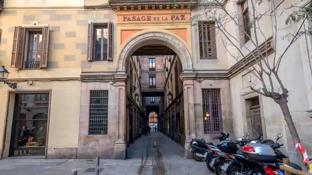 Video Reference: Building, Architecture, Town, Neighbourhood, Facade, Arch, Vehicle, Street, Arcade, Classical architecture, Person