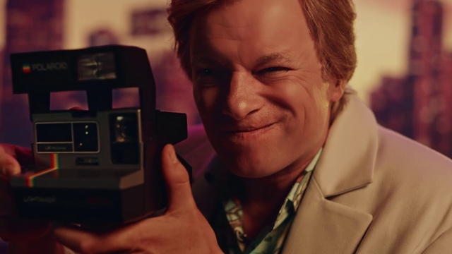 Video Reference: Electronics, Forehead, Human, Technology, Electronic device, Person, Man, Indoor, Holding, Looking, Camera, Front, Glasses, Wearing, Hand, Phone, Shirt, Standing, Smiling, Cellphone, Computer, Human face, Face, Selfie, Portrait, Smile