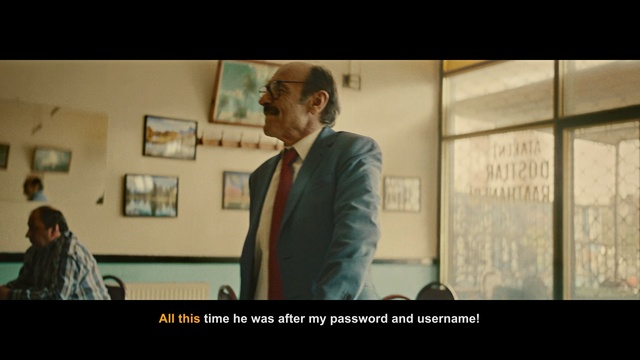 Video Reference: Text, Snapshot, Human, Gentleman, Photo caption, Font, Adaptation, Conversation, Presentation, Photography, Person, Man, Indoor, Photo, Looking, Suit, Standing, Front, Woman, Holding, Room, Walking, Mirror, Table, People, Group, Sign, Kitchen, Board, White, Screenshot, Human face, Tie, Clothing
