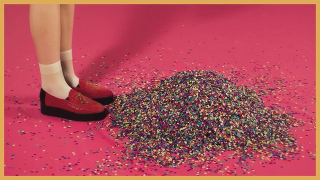 Video Reference: Carmine, Red, Sitting, Yellow, Ball, Table, Pink, Girl, Sign, Woman, Holding, White, Young, Text, Art