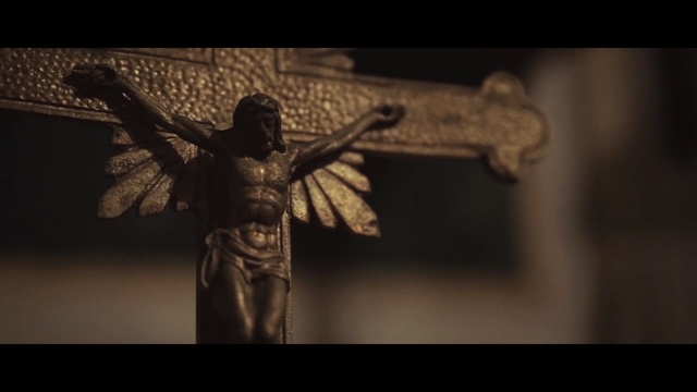 Video Reference: statue, darkness, religious item, artifact, crucifix, sculpture, monument, metal, screenshot, Person