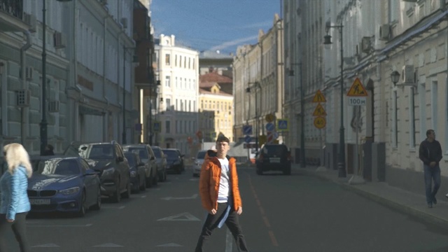 Video Reference: Lane, Town, Mode of transport, Street, Pedestrian, Neighbourhood, Urban area, Road, Snapshot, Human settlement, Person