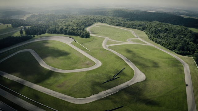 Video Reference: Sport venue, Race track, Aerial photography, Birds-eye view, Land lot, Landscape, Grass