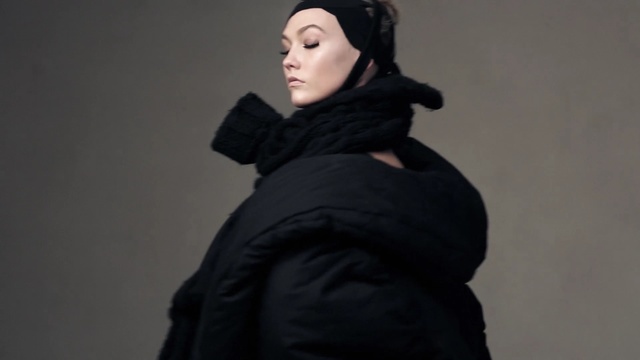 Video Reference: Black, Clothing, Neck, Outerwear, Scarf, Headgear, Fashion accessory, Hood, Black hair, Person