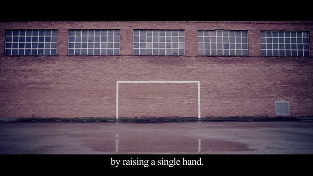 Video Reference: Wall, Sky, Line, Text, Architecture, Brick, Material property, Window, Sport venue, Asphalt