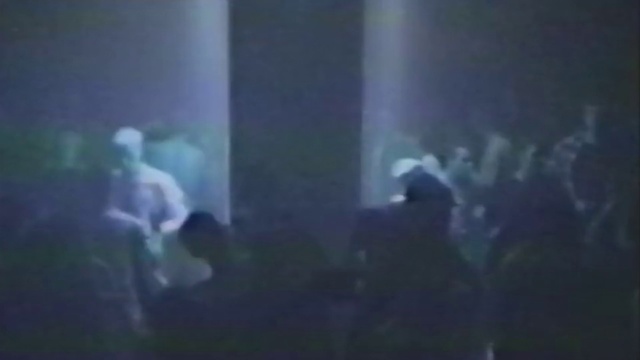 Video Reference: Black, Blue, Performance, Light, Atmosphere, Performing arts, Organism, Darkness, Rock concert, Music, Vessel, Aquarium, Thing, Indoor, Window, Monitor, Laptop, Screen, Room, Computer, Photo, Television, Blurry, Table, Glass, Looking, Front, Desk, Sitting, Dark, Bus, Living, Mirror, Reflection, Large, Cat, Driving, Man, White, Vase, Street, City, Red, Concert, Person, Ocean floor