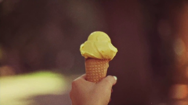 Video Reference: Ice cream cone, Gelato, Frozen dessert, Food, Sorbetes, Ice cream, Dessert, Soft serve ice creams, Dondurma, Dairy, Sitting, Table, Front, Vase, Mirror, Hat, White, Cake, Room, Man, Fast food, Snack, Soy ice cream, Baked goods, Muffin, Frozen yogurt, Delicious, Vanilla ice cream, Sweet, Italian ice, Chocolate, Chocolate ice cream, Cream, Sundae, Fruit