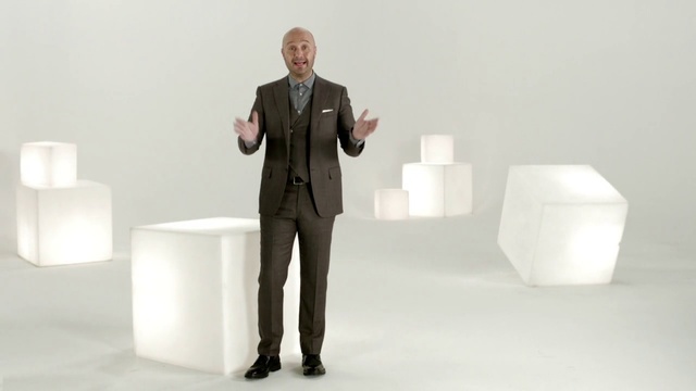 Video Reference: Suit, Standing, Businessperson, Design, Furniture, Material property, Formal wear, Table, Sitting, Business