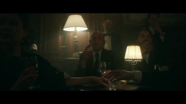 Video Reference: Darkness, Photograph, Black, Lighting, Light, Snapshot, Screenshot, Human, Lighting accessory, Fun, Person, Indoor, Man, Table, Sitting, Front, Looking, Wine, Glasses, Glass, Lit, Holding, Dark, Woman, Room, Shirt, Using, Laptop, Food, Phone, Mirror, Living, White, Standing, Candle, Lamp, Text, Wine glass