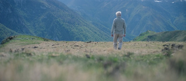 Video Reference: Mountainous landforms, Hill station, Grass, Atmospheric phenomenon, Grassland, Mountain, Hill, Ecoregion, Sky, Highland, Person