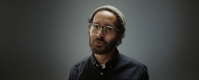 Video Reference: facial hair, glasses, beard, chin, vision care, eyewear, audio, audio equipment, portrait, microphone, Person
