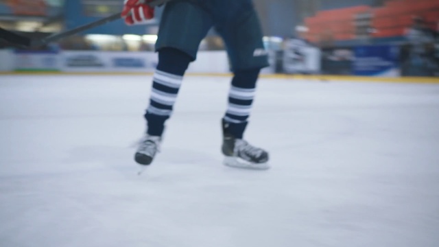 Video Reference: Ice skate, Ice skating, Ice rink, Skating, Sports equipment, Footwear, Leg, Recreation, Sports, Ice hockey equipment, Person