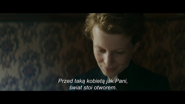 Video Reference: Text, Movie, Photo caption, Human, Adaptation, Screenshot, Smile, Font, Photography, Digital compositing, Person, Indoor, Man, Screen, Front, Photo, Looking, Laptop, Dark, Young, Sitting, Shirt, Computer, Monitor, Holding, Black, Television, White, Wearing, Table, Woman, Large, Standing, Sign, Room, Human face, Portrait