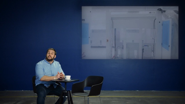 Video Reference: blue, sitting, lecture, lighting, communication, design, public speaking, technology, conversation, Person
