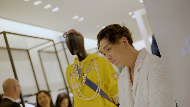 Video Reference: Yellow, Person, Indoor, Standing, Man, Woman, Young, Holding, Front, People, Table, Room, Wearing, Game, Laptop, Kitchen, Boy, White, Suit, Computer, Group, Video, Playing, Wii, Wall, Human face, Clothing