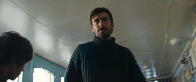 Video Reference: Facial hair, Beard, Neck, Moustache, Person, Indoor, Man, Standing, Looking, Holding, Front, Shirt, Room, Woman, Young, Video, People, Computer, Laptop, Kitchen, Playing, Game, Suit, White, Wall, Human face, Portrait, Clothing, Guy