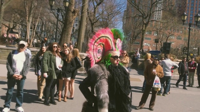 Video Reference: event, tree, crowd, festival, recreation, street, pedestrian, Person