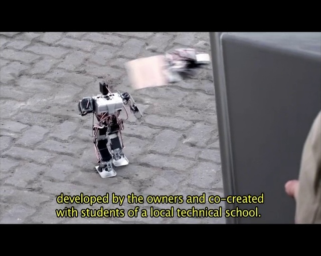 Video Reference: Robot, Photo caption, Machine, Technology, Font, Photography, Fictional character