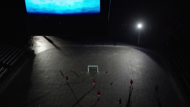 Video Reference: Light, Darkness, Lighting, Atmosphere, Line, Space, Technology, Room, Architecture, Photography, Indoor, Monitor, Sitting, Computer, Front, Dark, Table, Laptop, Television, Screen, Red, Black, White, Man, Keyboard, Traffic, Screenshot, Text