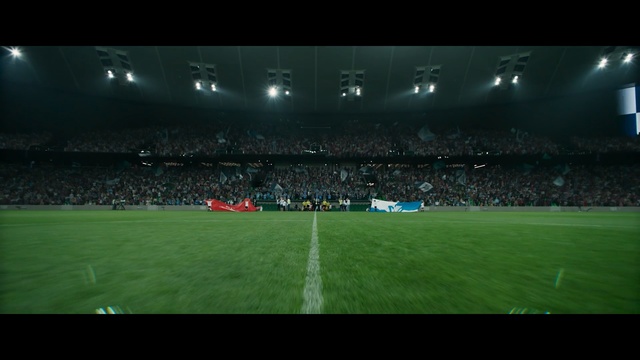 Video Reference: Stadium, Sport venue, Arena, Atmosphere, Soccer-specific stadium, Football, Player, Team sport, Ball game, Grass, Building, Field, Man, Game, Ball, Large, Playing, Standing, Green, People, Ready, Night, Soccer, Match, Holding, Court, Baseball, White, Group, Red, Swinging, Air, Riding, Sign, Person, Artificial turf