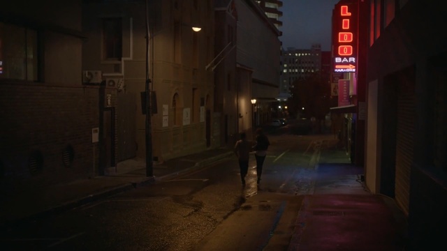 Video Reference: alley, street, darkness, infrastructure, night, light, urban area, snapshot, road, atmosphere, Person