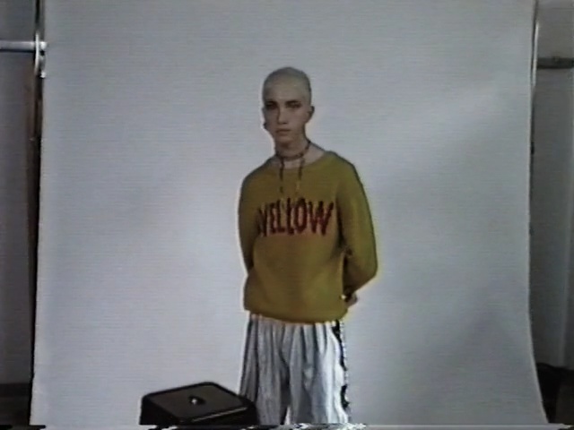 Video Reference: standing, shoulder, joint, t shirt, arm, muscle, outerwear, sportswear, neck, physical fitness, Person