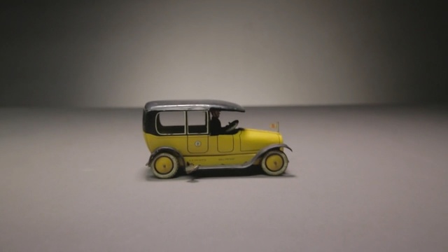 Video Reference: Land vehicle, Vehicle, Motor vehicle, Yellow, Car, Mode of transport, Model car, Vintage car, Automotive wheel system, Classic car, Person