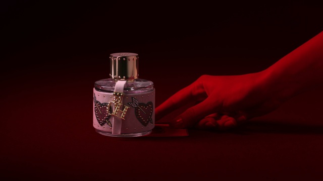 Video Reference: Perfume, Product, Liquid, Still life photography, Fluid, Glass bottle, Magenta, Material property, Hand, Cosmetics