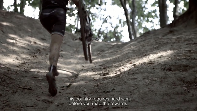 Video Reference: tree, trail, soil, path, adventure, race, vehicle, recreation, sports equipment, forest, Person