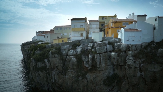 Video Reference: Sky, Water, Architecture, House, Sea, Cliff, Terrain, Coast, Tree, Building