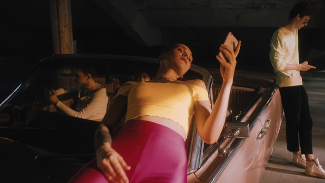 Video Reference: Human body, Sportswear, Muscle, Performance, Dance, Abdomen, Party, Leisure, Vacation, Person, Indoor, Woman, Car, Man, Girl, Pulling, Front, Standing, Sitting, Young, Holding, Suitcase, Luggage, Table, Shirt, Laptop, Red, Oven, People, Riding, Phone, White, Room, Player, Playing, Human face, Clothing