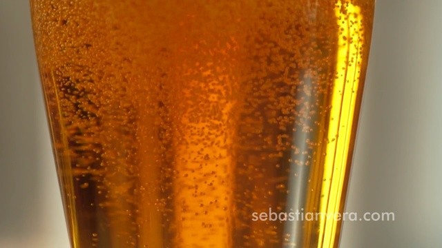 Video Reference: Beer glass, Beer, Pint glass, Drink, Caramel color, Champagne cocktail, Amber, Pint, Lager, Wheat beer, Cup, Indoor, Thing, Sitting, Table, Glass, Close, Food, Abstract, Gold, Text, Yellow, Soft drink