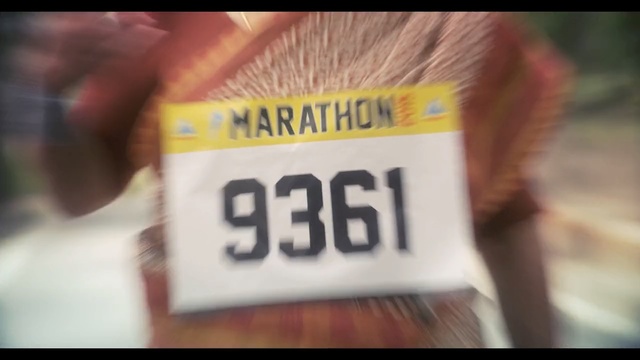 Video Reference: Vehicle registration plate, Text, Font, Automotive exterior, Number, Label, T-shirt, Close-up, Material property, Textile