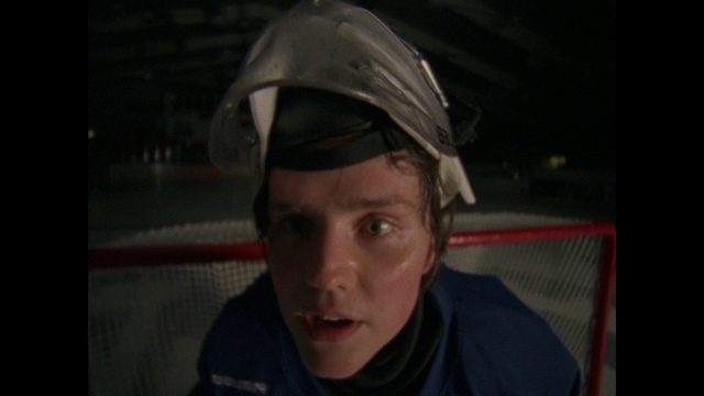 Video Reference: Face, Forehead, Head, Nose, Helmet, Chin, Cheek, Cool, Eyewear, Glasses, Person, Indoor, Man, Wearing, Holding, Front, Baseball, Looking, Sitting, Young, Hat, Black, Bat, Plate, Shirt, Boy, Smiling, White, Table, Phone, Standing, Human face, Clothing, Personal protective equipment, Headgear