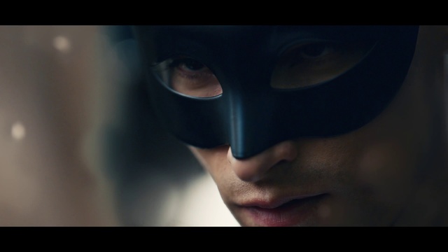 Video Reference: Eyewear, Batman, Close-up, Fictional character, Eye, Headgear, Mask, Supervillain, Photography, Person, Indoor, Clothing, Man, Looking, Wearing, Holding, Black, Glasses, Screen, Close, Head, White, Young, Standing, Hat, Room, Eyes, Face, Screenshot, Human face