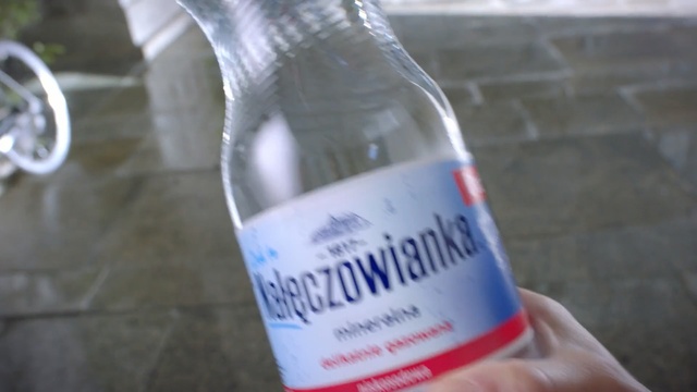 Video Reference: Bottle, Water, Alcohol, Drink, Product, Glass bottle, Liqueur, Alcoholic beverage, Distilled beverage, Label, Person